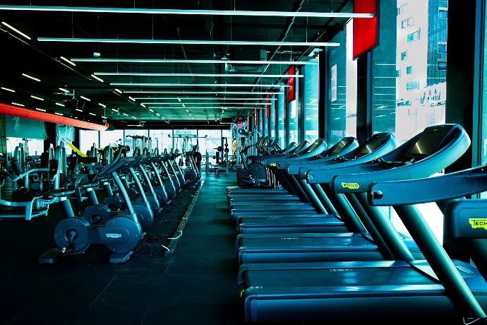a row of exercise machines in a gym